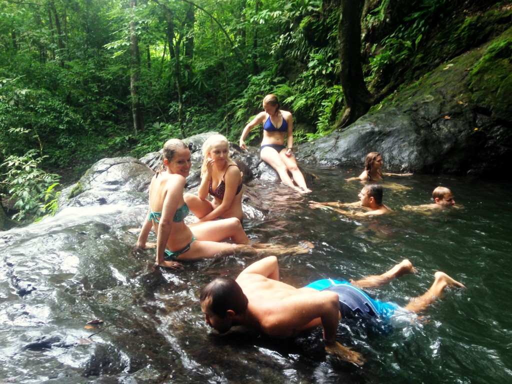 Academia Tica students relaxing in the refreshing pool between two waterfalls. 