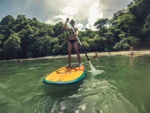 Stand up paddling surf in Jacó Beach, Costa Rica